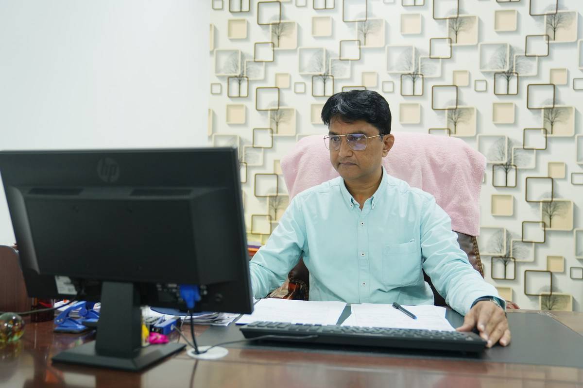 Mr. Trushar Hasmukhbhai Patel working at his desk